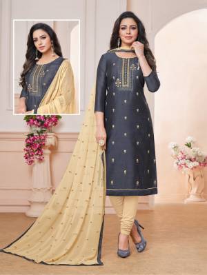 Grab This Pretty Dress Material For Your Semi-Casuals In Dark Grey Colored Top paired With Cream Colored Bottom And Dupatta. Its Embroidered Top Is Fabricated On Art Silk Paired With Cotton Bottom And Chiffon Fabricated Embroidered Dupatta. Buy Now