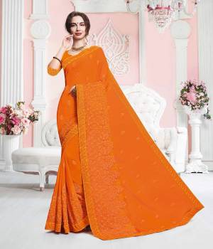 Celebrate This Festive Season In Traditionals Wearing This Designer Saree In Orange Color. This Saree Is Georgette Based Beautified With Subtle Tone To Tone Embroidery. Buy This Pretty Saree Now.