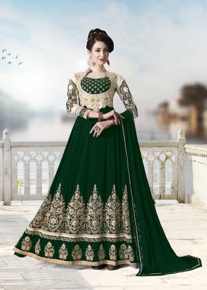 Get Ready For The Upcoming Festive And Wedding Season With This Heavy Designer Floor Length Suit In Dark Green Color. Its Heavy Embroidered Top Is Fabricated On Georgette Paired With Santoon Bottom and Chiffon Fabricated Dupatta. All Its Fabrics Ensures Superb Comfort Throughout The Gala. Buy Now.