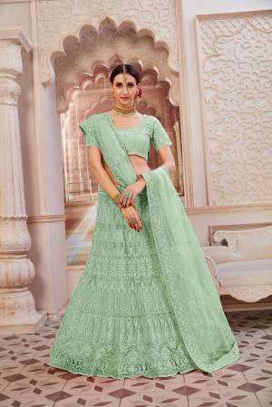 This Wedding Season Be The Most Sensational Diva Wearing This Heavy Designer Lehenga Choli In Mint Green Color. This Pretty Blouse, Lehenga And Dupatta Are Fabricated On Net Beautified With Tone To Tone Coding And Resham Embroidery With Stone Work. Buy This Designer Piece Now.