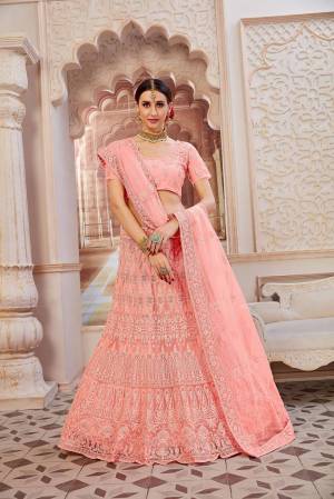 This Wedding Season Be The Most Sensational Diva Wearing This Heavy Designer Lehenga Choli In Light Pink Color. This Pretty Blouse, Lehenga And Dupatta Are Fabricated On Net Beautified With Tone To Tone Coding And Resham Embroidery With Stone Work. Buy This Designer Piece Now.