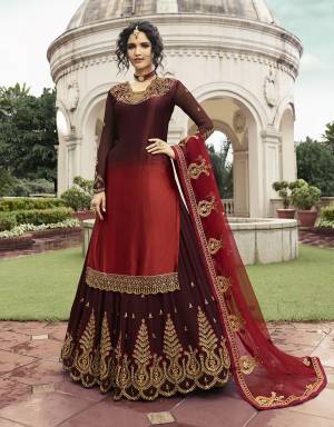 This Wedding Season Be The Most Unique One Wearing This Indo-Western Lehenga Suit In Maroon And Red Color. Its Top Is Fabricated On Satin Georgette Paired With Georgette Lehenga And Net Fabricated Dupatta. Its Top, Bottom And Dupatta aRe Beautified With Heavy Embroidery Work. 