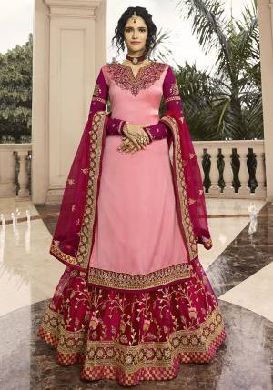 Go With The Shades Of Pretty Pink With This Designer Indo-Western Lehenga Suit In Pink Colored Top Paired With Rani Pink Colored Lehenga And Dupatta. Its Top Is Fabricated On Satin Georgette Paired With Net Fabricated Lehenga And Dupatta. Buy Now.