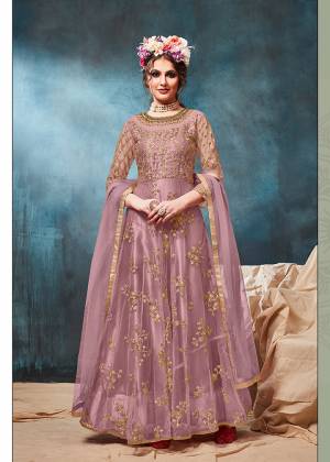 Get Ready For The Upcoming Wedding And Festive Season With This Heavy Designer Floor Length Suit In Mauve Color. Its Heavy Embroidered op Is Fabricated On Net Paired With Santoon Bottom And Net Fabricated Dupatta. Buy Now.
