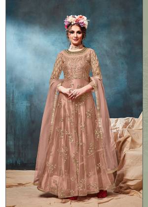 Get Ready For The Upcoming Wedding And Festive Season With This Heavy Designer Floor Length Suit In Dusty Peach Color. Its Heavy Embroidered op Is Fabricated On Net Paired With Santoon Bottom And Net Fabricated Dupatta. Buy Now.