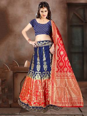 This Festive Season Have A Proper Traditional Look Wearing This Silk Based Lehenga Choli In Navy Blue Color Paired With Contrasting Red Colored Dupatta. This Lehenga Choli Is Fabricated On Banarasi Jacquard Silk Beautified With Weave All Over. 