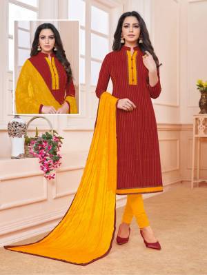 Add Some Semi-Casuals To Your Wardrobe With This Designer Straight Suit In Maroon Colored Top Paired With Contrasting Musturd Yellow Colored Bottom And Dupatta. This Dress Material IS Cotton Based Paired With Chiffon Fabricated Embroidered Dupatta. Buy Now.