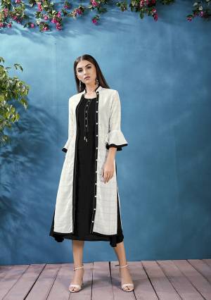 For A Bold and Beautiful Look Grab This Designer Readymade Kurti In Black Color Which Comes With A White Colored Jacket. This Plain Kurti IS Rayon Based Paired With Handloom Cotton Fabricated Thread Embroidered Jacket. 