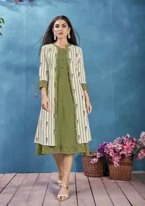 Add This Pretty Readymade Kurti To Your Wardrobe In Olive Green Color Paired With Off-White Colored Jacket, This Kurti and Jacket Are Cotton Based Beautified With Prints And Thread Work. 