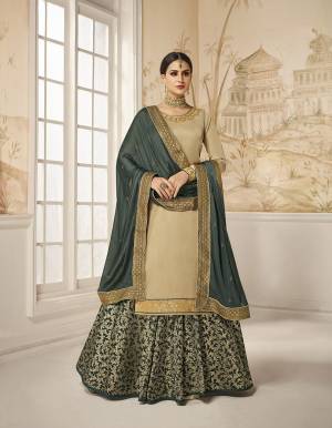 Flaunt Your Rich And Elegant Taste Wearing This Designer Indo-Western Suit In Beige Colored Top Paired With Contrasting Dark Teal Green Colored Bottom And Dupatta. Its Embroidered Top Is Fabricated On Satin Silk Paired With Jacquard Silk Bottom And Georgette Silk Fabricated Dupatta. As Per Your Choice You Can Its Bottom Stitched As A Plazzo Or Skirt. 