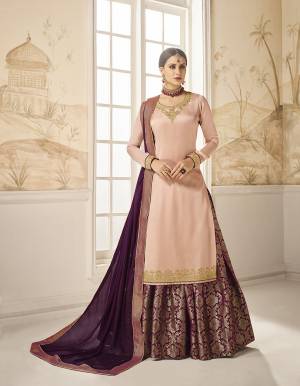 Choose Your Indo-Western Style As Per Occasion And You Can Get Its Bottom Stitched As Skirt Or Plazzo. Its Pretty Top Is In Pink Color Paired With Contrasting Purple Colored Bottom And Dupatta. Its Top Is Fabricated On Satin Silk Paired With Jacquard Silk Bottom And Georgette Silk Fabricated Dupatta. Buy This Lovely Designer Piece Now.
