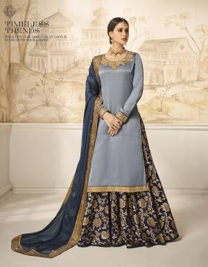 Choose Your Indo-Western Style As Per Occasion And You Can Get Its Bottom Stitched As Skirt Or Plazzo. Its Pretty Top Is In Steel Blue Color Paired With Navy Blue Colored Bottom And Dupatta. Its Top Is Fabricated On Satin Silk Paired With Jacquard Silk Bottom And Georgette Silk Fabricated Dupatta. Buy This Lovely Designer Piece Now.