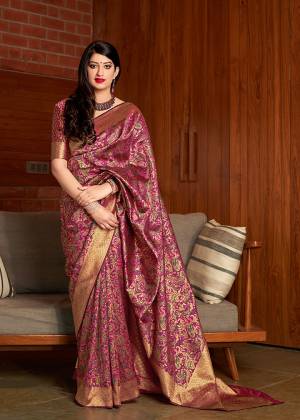Adorn The Angelic Look Wearing This Designer Silk Based Saree In Magenta Pink Color Paired With Magenta Pink And Gold Colored Blouse. This Saree And Blouse Are Fabricated On Banarasi Art Silk. 