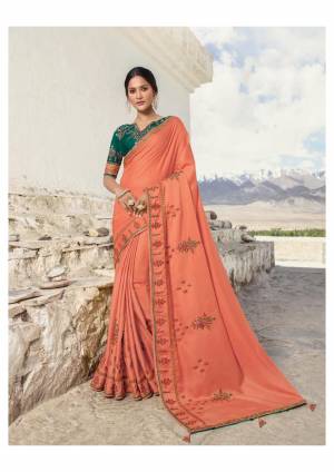 Bright And Visually Appealing Shade Is Here In Orange Color Paired With Contrasting Teal Green Colored Blouse. This Pretty Saree Is Fabricated On Soft Silk Paired With Art Silk Fabricated Blouse. Buy Now.