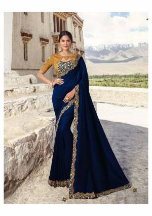 Get Ready For The Upcoming Festive And Wedding Season With This Designer Saree In Royal Blue Color Paired With Contrasting Musturd Yellow Colored Blouse. This Saree Is Fabricated On Soft Silk Paired With Satin Silk And Art Silk Fabricated Blouse. Its Color Pallete And Rich Fabric Will Definitely Earn You lots Of Compliments From Onlookers. 