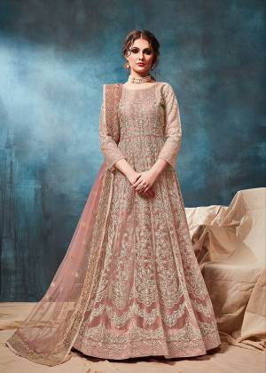 Grab This Very Beautiful and Attractive Looking Heavy Designer Floor Length Suit In Dusty Peach Color. Its Top And Dupatta Are Fabricated On Net Beautified With Coding Work Paired With Santoon Fabricated Bottom. It Is Prefectly Suitable For The Wedding And Festive Season. Buy Now.
