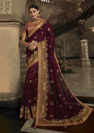 You Will Definitely Earn Lots Of Compliments Wearing This Heavy Designer Saree In Wine Color Paired With Contrasting Dusty Pink Colored Blouse. This Saree And Blouse Are Silk based Beautified With Heavy Detailed Embroidery. Buy This Beautiful Saree Now.