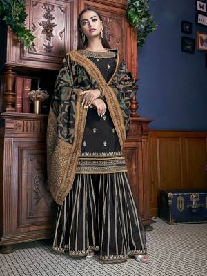 For A Bold And Beautiful Look, Grab This Elegant Looking Designer Sharara Suit In All Over Black Color. Its Top IS fabricated On Art Silk Paired With Net Fabricated Bottom And Jacquard Silk Fabricated Dupatta. 