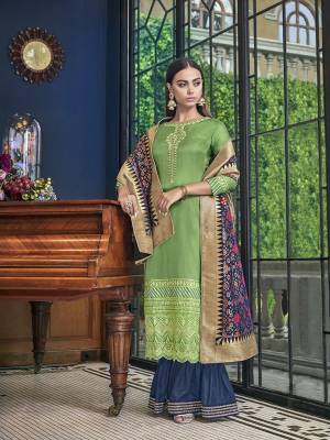 Adorn A Total New Look Wearing This Designer Sharara Suit In Green Colored Top Paired With Contrasting Dark Blue Colored Bottom And Dupatta. Its Top Is Satin Silk Based Paired With Art Silk Bottom And Jacquard Silk Fabricated Dupatta. 