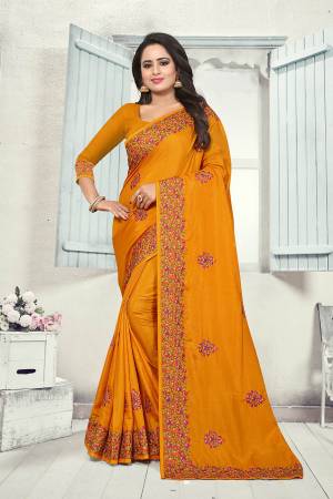 Here Is A Very Pretty Kashmiri Embroidered Designer Saree In Musturd Yellow Color. This Pretty Saree And Blouse Are Silk Based With Heavy Embroidered Multi Colored Lace Border. 