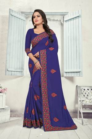 Here Is A Very Pretty Kashmiri Embroidered Designer Saree In Royal Blue Color. This Pretty Saree And Blouse Are Silk Based With Heavy Embroidered Multi Colored Lace Border. 