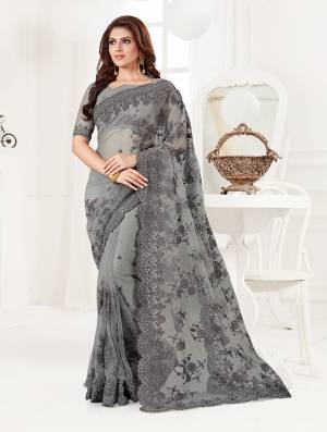 Here Is A Very Beautiful And Heavy Designer Saree In Grey Color. This Beautiful Heavy Embroidered Saree And Blouse Are Fabricated On Net Beautified With Pretty Tone To Tone Resham Embroidery And Ceramic Stone Work. Buy This Heavy Yet Subtle Looking Saree Now.