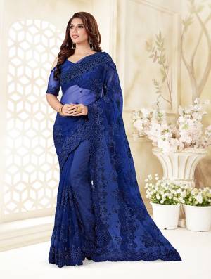 Here Is A Very Beautiful And Heavy Designer Saree In Royal Blue Color. This Beautiful Heavy Embroidered Saree And Blouse Are Fabricated On Net Beautified With Pretty Tone To Tone Resham Embroidery And Ceramic Stone Work. Buy This Heavy Yet Subtle Looking Saree Now.