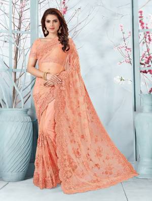 Here Is A Very Beautiful And Heavy Designer Saree In Peach Color. This Beautiful Heavy Embroidered Saree And Blouse Are Fabricated On Net Beautified With Pretty Tone To Tone Resham Embroidery And Ceramic Stone Work. Buy This Heavy Yet Subtle Looking Saree Now.
