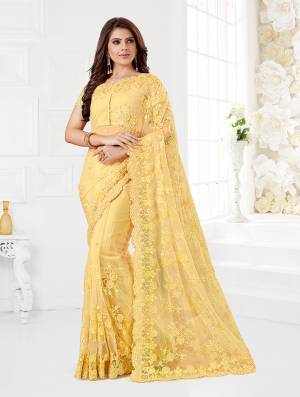 Here Is A Very Beautiful And Heavy Designer Saree In Yellow Color. This Beautiful Heavy Embroidered Saree And Blouse Are Fabricated On Net Beautified With Pretty Tone To Tone Resham Embroidery And Ceramic Stone Work. Buy This Heavy Yet Subtle Looking Saree Now.