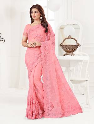 Here Is A Very Beautiful And Heavy Designer Saree In Pink Color. This Beautiful Heavy Embroidered Saree And Blouse Are Fabricated On Net Beautified With Pretty Tone To Tone Resham Embroidery And Ceramic Stone Work. Buy This Heavy Yet Subtle Looking Saree Now.