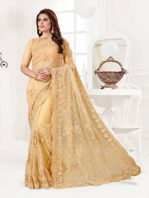 Here Is A Very Beautiful And Heavy Designer Saree In Yellow Color. This Beautiful Heavy Embroidered Saree And Blouse Are Fabricated On Net Beautified With Pretty Tone To Tone Resham Embroidery And Ceramic Stone Work. Buy This Heavy Yet Subtle Looking Saree Now.