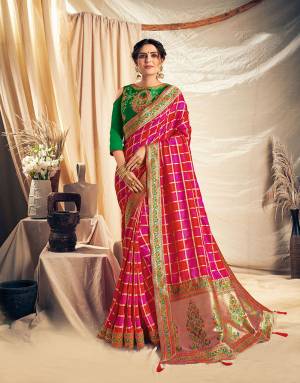 Look festival ready and perfect that traditional look in this beautiful pink, red and green checkered saree. Adorn with stylish jhumkis to complete the look. 