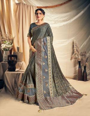 Appear like a melodious song in this beautifully designed Dark grey saree with a hint of modernity. Pair with silver jewels to look conventionally modern. 