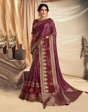 Shine throught the festivities in this graceful and regal Wine Colored Designer saree adorned with weaved appliqued buttis. Pair with delicate gold jewels to complete the look. 