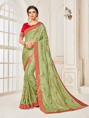 For A Proper Traditional Look, Grab This Designer Silk Based Saree In Light Green Color Paired With Contrasting Red Colored Blouse. Its Rich Fabric And Color Will Earn You Lots Of Compliments From Onlookers.