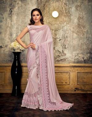 Tell the tale of glamour and class in this stylish and frilly saree and attract just the right amount of attention. Drape the pallu in half-falling style for a perfect look. 
