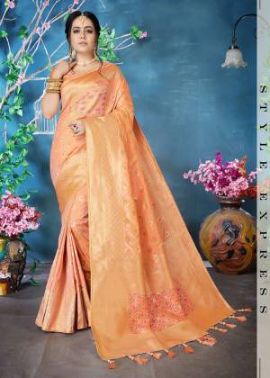Must Have Shade In Every Womens Wardrobe Is Here With This Lovely Peach Colored Saree Paired With peach Colored Blouse. This Saree And Blouse Are Fabricated On Banarasi Art Silk Beautified With Weave All Over. 