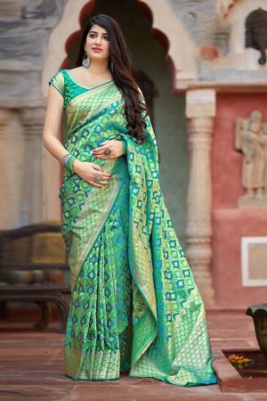 Flaunt Your Rich And Elegant Taste In Silk With This Subtle Weaved Saree In Green Color. This Saree And Blouse Are Fabricated On Banarasi Satin Beautified With Pretty Small Butti Weave All Over It. Its Silk Based Fabric Will Give A Rich Look To Your Personality