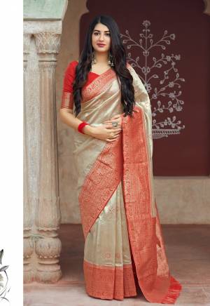Flaunt Your Rich And Elegant Taste In Silk With This Subtle Weaved Saree In Cream Color. This Saree And Blouse Are Fabricated On Banarasi Art Silk Beautified With Pretty Small Butti Weave All Over It. Its Silk Based Fabric Will Give A Rich Look To Your Personality