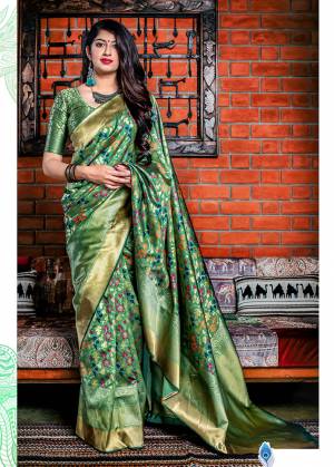 Flaunt Your Rich And Elegant Taste In Silk With This Subtle Weaved Saree In Green Color. This Saree And Blouse Are Fabricated On Banarasi Art Silk Beautified With Pretty Small Butti Weave All Over It. Its Silk Based Fabric Will Give A Rich Look To Your Personality