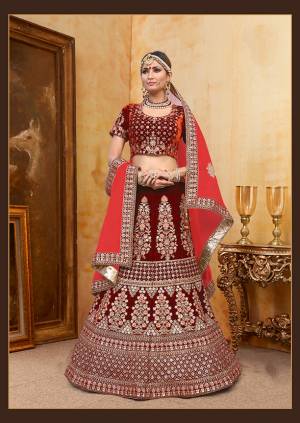 Be The Prettiest Bride Wearing This Very Beautiful And Heavy Embroidered Designer Bridal Lehenga Choli In Maroon Color Paired With Contrasting Red Colored Blouse. This Lehenga Choli Is Velvet Based Paired With Net Fabricated Dupatta. Buy This Beautiful Lehenga Choli Now.