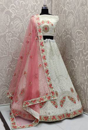 Rich And Elegant Looking Heavy Designer Lakhnavi Lehenga Choli Is Here In White Color Paired With Pretty Pink Colored Dupatta. This Heavy Embroidered Lehenga Choli Is Fabricated On Georgette Paired With Net Fabricated Dupatta. Buy This Lovely Piece Now.