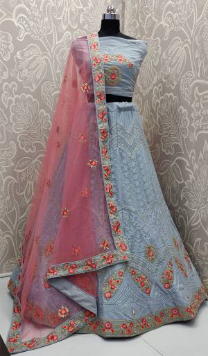 You Will Definitely Earn Lots Of Compliments Wearing This Heavy Designer Lakhnavi Lehenga Choli In Powder Blue Color Paired With Contrasting Pink Colored Dupatta. This Lehenga Choli Is Fabricated On Georgette Paired With Net Fabricated Dupatta. Buy Now. 