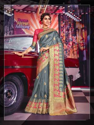 Flaunt Your Rich And Elegant Taste Wearing This Designer Silk Based Saree In Grey Color Paired With Contrasting Rani Pink Colored Blouse. Its Rich Color And Fabric Will Earn You Lots Of Compliments From Onlookers.