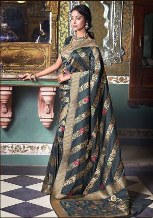 Flaunt Your Rich and Elegant Taste Wearing This Designer Saree In Dark Grey Color Paired With Dark Grey Colored Blouse. This Saree And Blouse Are Silk Based Beautified With Weave All Over. 