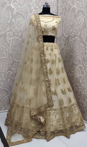 Get Ready For The Upcoming Wedding Season With This Very Beautiful And Heavy Designer Lehenga Choli In All Over Cream Color. This Heavy Embroidered Lehenga Choli Is Fabricated On Net Beautified With Tone To Tone Embroidery. 