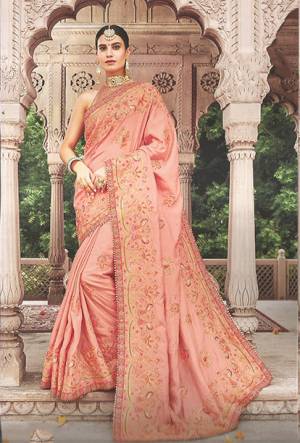 You Will Definitely Earn Lots Of Compliments Wearing This Heavy Designer Saree In Dark Peach Color. This Pretty Heavy Embroidered Saree Is Fabricated On Art Silk Paired With Art Silk And Net fabricated Blouse. It IS Beautified With Contrasting And Attractive Looking Detailed Embroidery. 