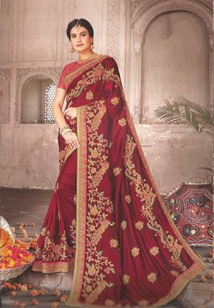 For A Proper Traditional Look, Grab This Royal Looking Heavy Designer Saree In Maroon Color Paired With Contrasting Dark Pink Colored Blouse. This Rich And Heavy Embroidered Saree And Blouse Are Silk Based. Buy This Pretty Saree Now. 