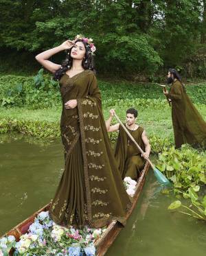 You Will Definitely Earn Lots Of Compliments Wearing This Rich Looking Designer Saree In Olive Green Color Paired With Olive Green Colored Blouse. This Embroidered Saree Is Georgette Based Paired With Art Silk Fabricated Blouse. 