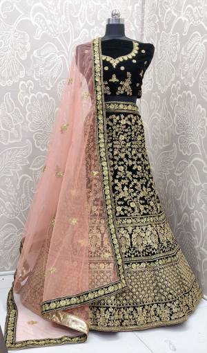 Here Is A Heavy Embroidered Designer Bridal Lehenga Choli For Your D-Day. This Heavy Velvet Based Lehenga Choli Is In Dark Green Color Paired With Baby Pink Colored Net Fabricated Dupatta. It Is Beautified With Heavy Jari And Coding Embroidery With Stone Work. 